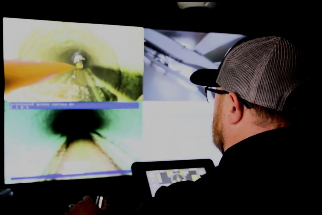 Photo of a man operating cctv robot